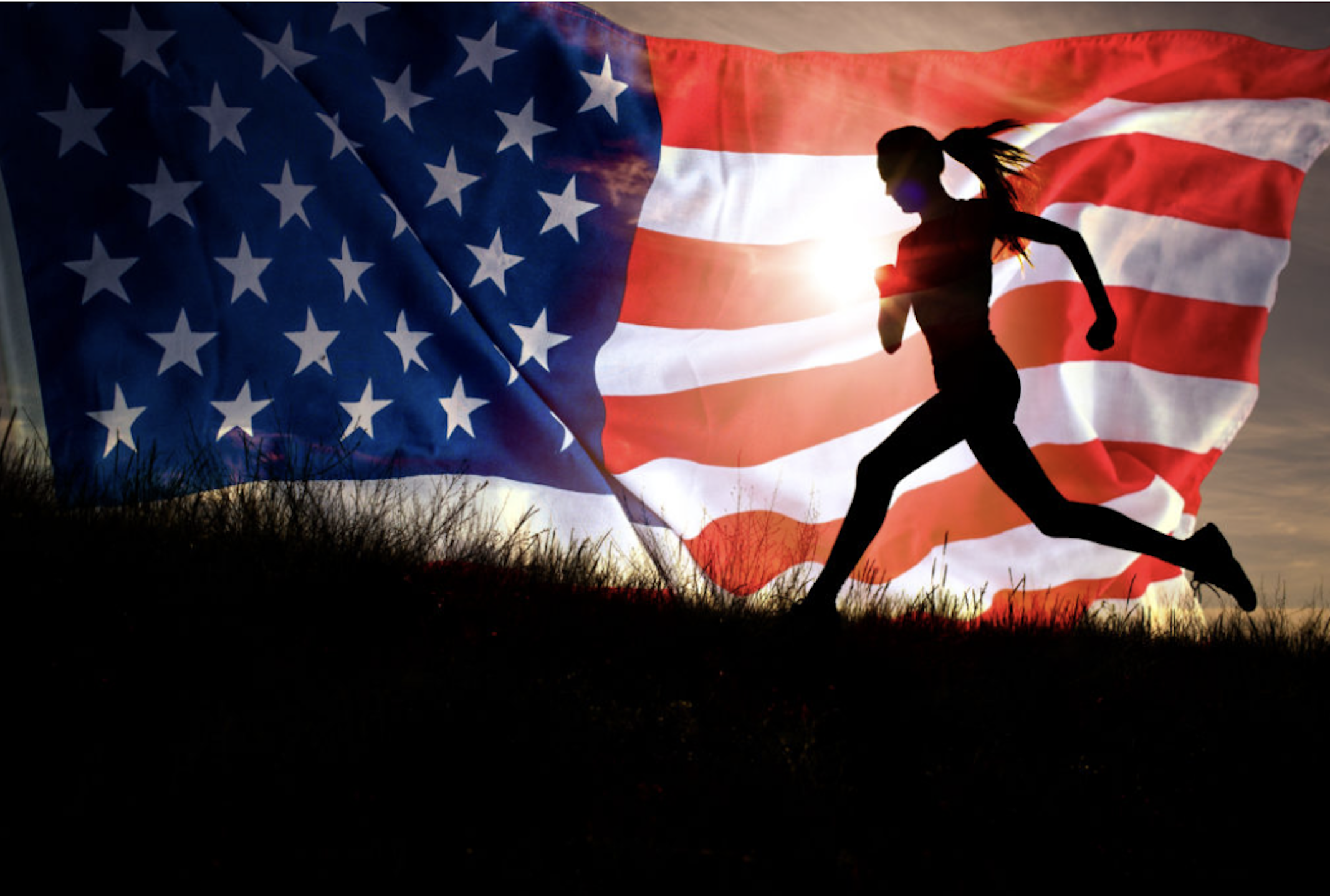 Runner passing in front of a large flag backdrop during an outdoor event